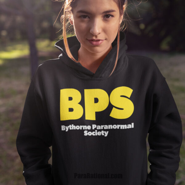 Female paranormal investigator wearing a black BPS Bythorne Paranormal Society Pullover Hoodie
